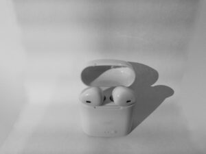 AirPods 3 in an open charging case on a textured background.