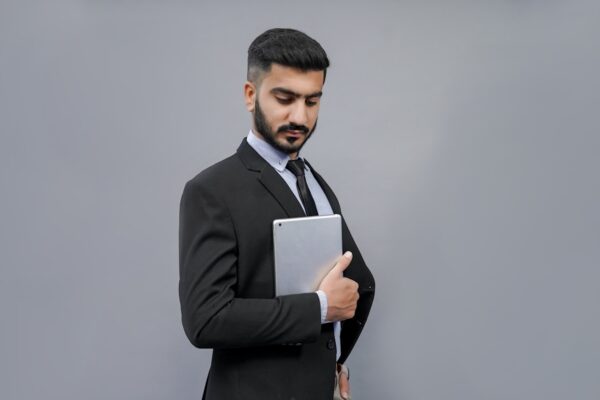 a man holding a tablet