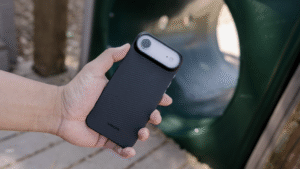 guy holding a super-thin iPhone Air case for the iPhone Air white color with a playground as background