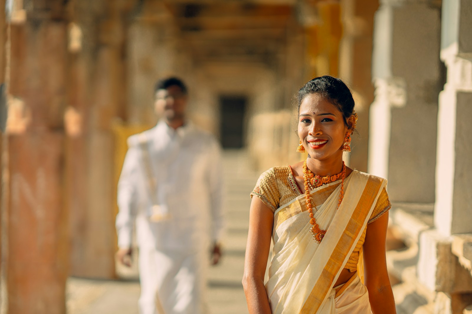 A woman in a white sari and a man in a white turban
