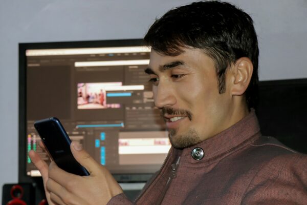 a man is looking at his cell phone