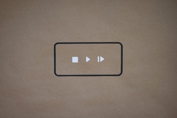 a black and white button on a brown background