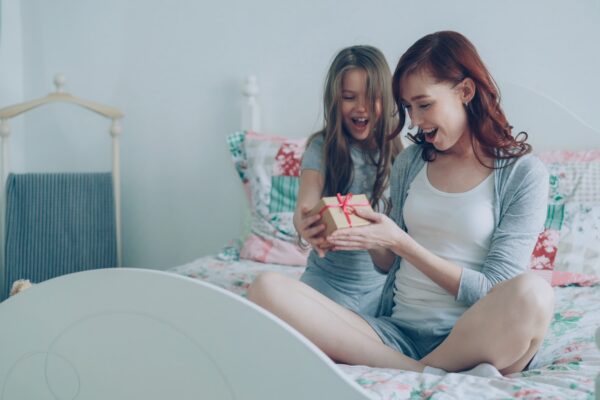 A daughter gives her mother a present.