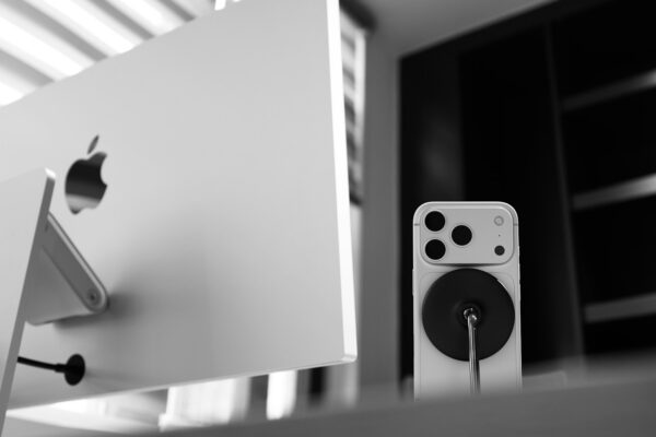 Apple computer monitor with iPhone and charger