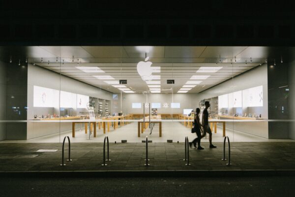 man and woman passing by store
