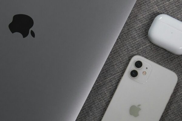 white apple remote beside white remote control