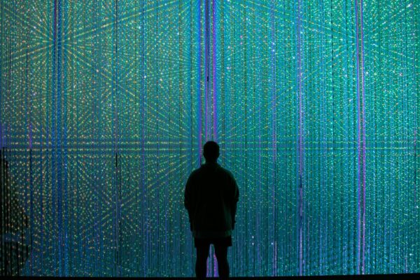 a person standing in front of a wall of lights