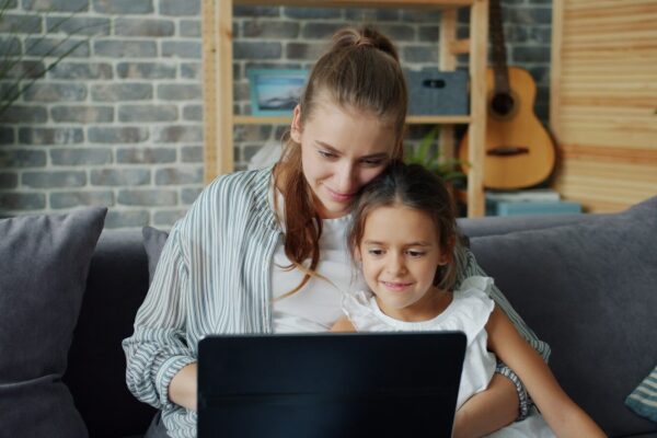 Mother and daughter looking at laptop together