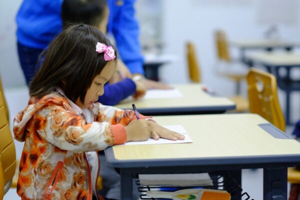 toddler sitting on desk