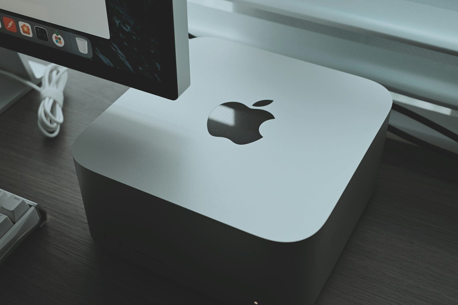 an apple computer sitting on top of a wooden desk
