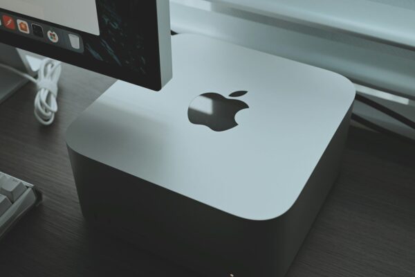 an apple computer sitting on top of a wooden desk